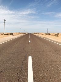 Diminishing perspective of empty road against sky