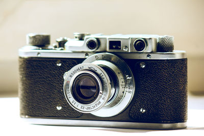 Close-up of old camera against white background