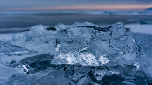 Close-up of frozen sea against sky. baykal.