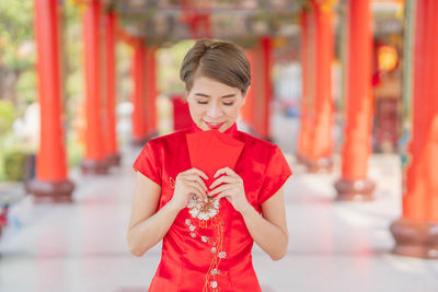 Full length of a girl holding red umbrella