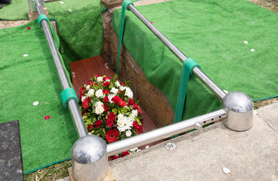 Closeup shot of a funeral casket or coffin in a hearse or chapel or burial at cemetery
