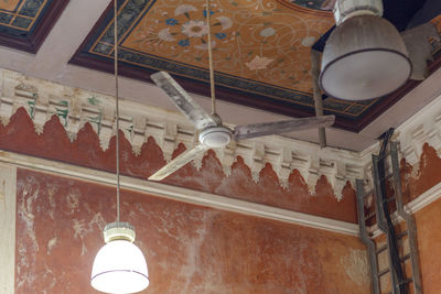 Low angle view of illuminated pendant light in building