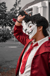 Side view of young woman wearing mask