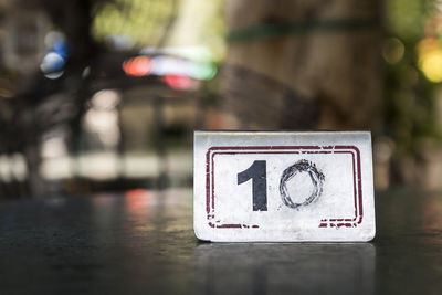 Shine metal sign number 10 on table in blur background