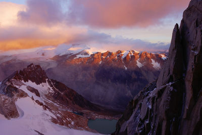 Scenic view of snowcapped mountains against sky during sunset