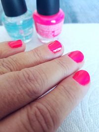 Close-up of woman hand holding pink bottle