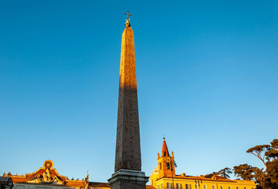 Low angle view of tower against blue sky