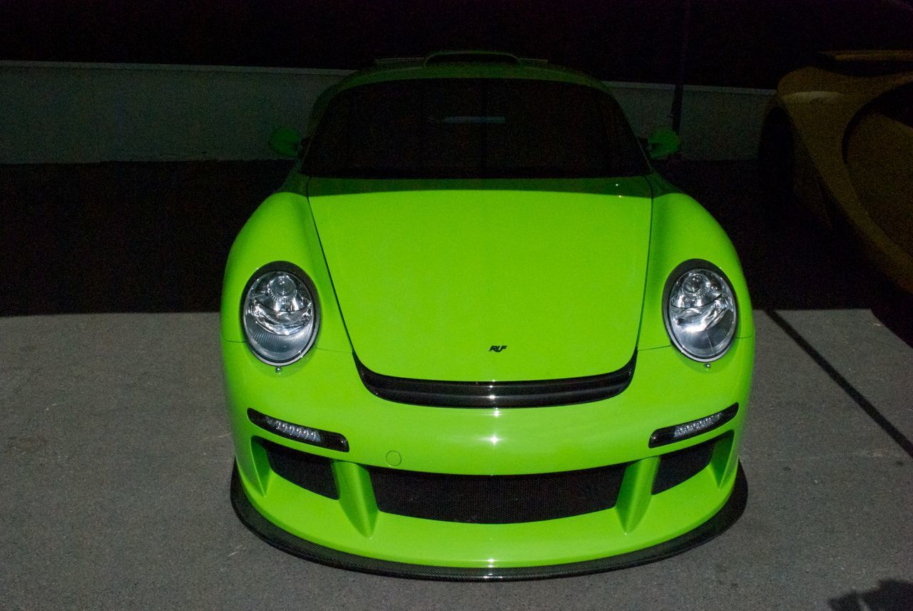 HIGH ANGLE VIEW OF GREEN CAR ON STREET