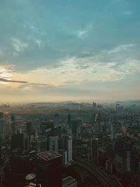 High angle view of city buildings against sky during sunset