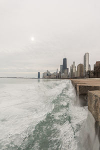 Scenic view of sea and buildings against sky