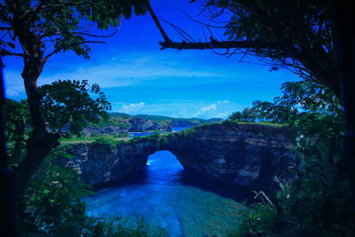 Scenic view of waterfall against sky