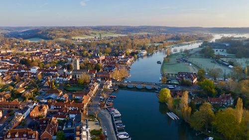 Aerial view of river amidst buildings in town