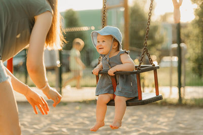 Side view of boy playing with ball at playground