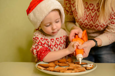 Laughing boy bake homemade festive gingerbreads. homemade baking