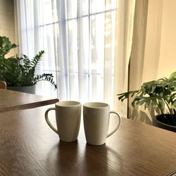 Glass of potted plant on table at home