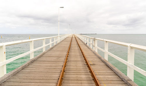 Pier over sea against sky