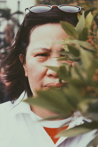 Portrait of woman by plants