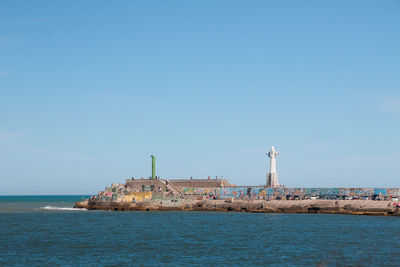 Scenic view of sea against clear blue sky