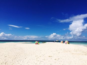 Scenic view of beach against blue sky