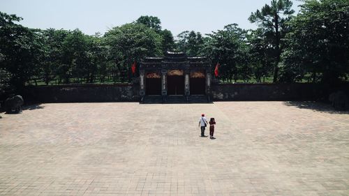 Men in temple against trees