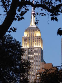 Low angle view of illuminated building against blue sky