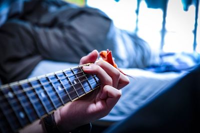 Cropped hand playing guitar