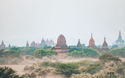 Temple on landscape against clear sky