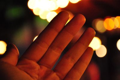 Close-up of hand holding illuminated lights