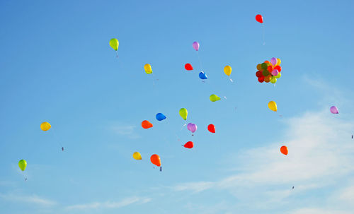 Low angle view of colorful balloons in sky
