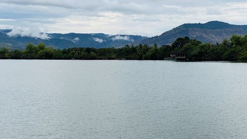 Scenic view of lake and mountains against sky