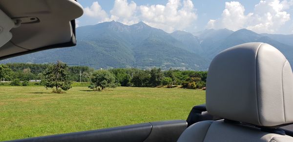 Scenic view of land and mountains against sky