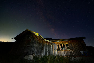 Low angle view of abandoned building against sky at night