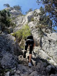 Rear view of man walking on rock