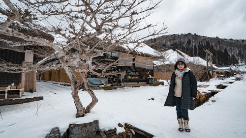 Rear view of woman walking on snow