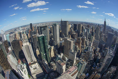 Aerial view of modern buildings in city against sky