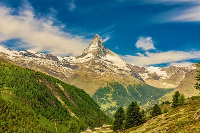 Scenic view of mountains against cloudy sky