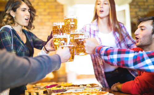 Smiling young woman drinking glass at restaurant