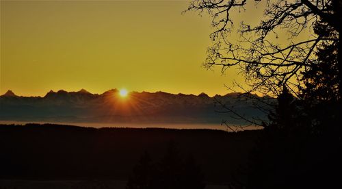 Scenic view of silhouette mountains against sky at sunset