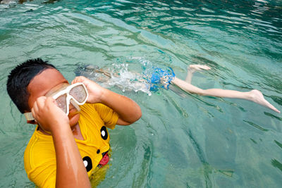 Boy swimming in sea