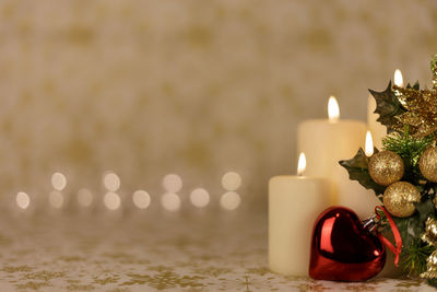 Close-up of lit candles on table