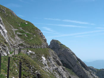 Scenic view of mountains against blue sky