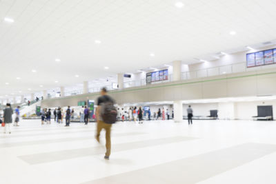 People walking in illuminated corridor