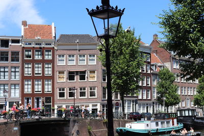 Buildings by street against sky in city