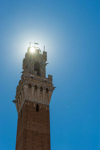 Low angle view of bell tower against blue sky