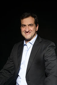 Portrait of mid adult man against black background