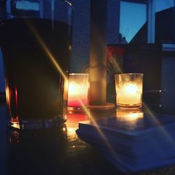 Close-up of illuminated candles on table