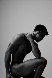 Side view of shirtless young woman