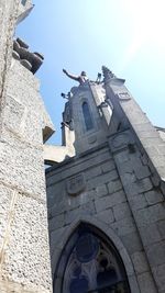 Low angle view of bell tower against sky