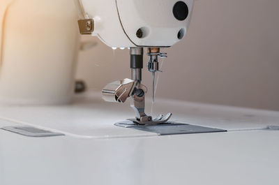 Sewing machine. sewing machine needle. foot sewing machine with thread inserted on needle.
