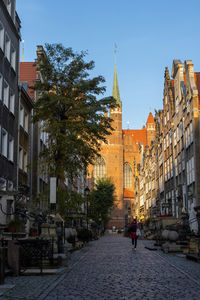 Street amidst buildings against sky in city